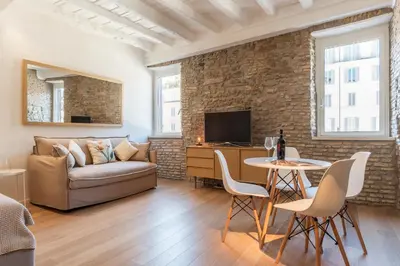 a living room with a couch and a table at Campo De' Fiori Apartment - Charme Holidays in Rome
