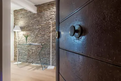 a door in a room with a brick wall at Campo De' Fiori Apartment - Charme Holidays in Rome