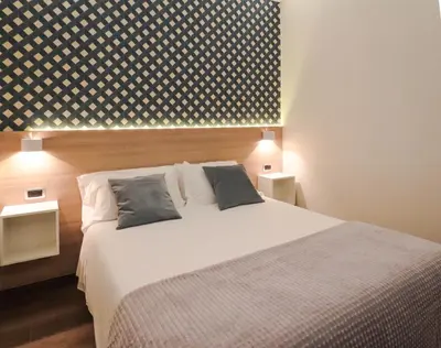 a bedroom with a large white bed with two pillows at My Maison 109 Guest House in Rome