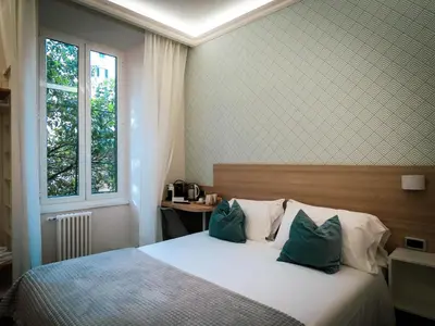 a bedroom with a bed with two pillows and a window at My Maison 109 Guest House in Rome