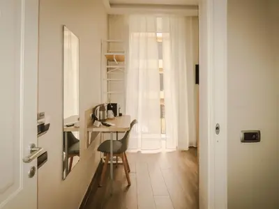a room with a desk and a chair and a table at My Maison 109 Guest House in Rome