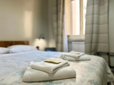 a bedroom with a bed with towels on it at B&B Santi Quattro Al Colosseo in Rome