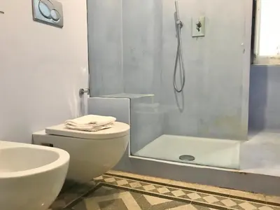 a bathroom with a shower and a toilet and a sink at B&B Santi Quattro Al Colosseo in Rome