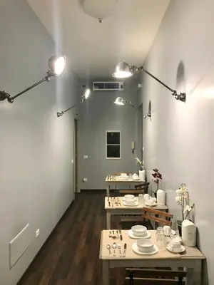a room with two tables with plates on them at B&B Santi Quattro Al Colosseo in Rome