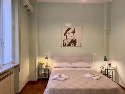 a bedroom with a bed with two towels on it at B&B Santi Quattro Al Colosseo in Rome