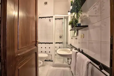 a bathroom with a sink and a toilet and a sink at Appartamento via dei Baullari in Rome