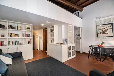 a living room with white cabinets and a table in it at Appartamento via dei Baullari in Rome