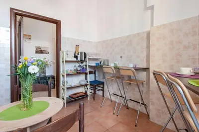 a kitchen with a table with a vase of flowers on it at Casa Via Cesena in Rome
