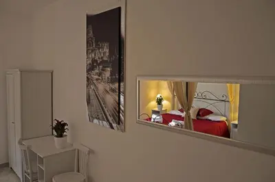 a bedroom with a bed and a mirror on the wall at Casa Via Cesena in Rome