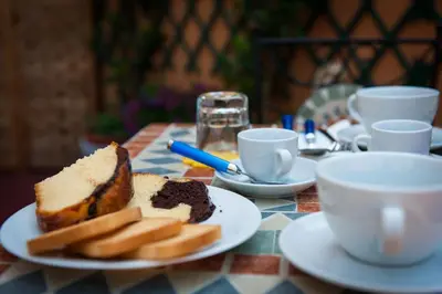 a plate with a piece of cake and cookies on a table at Casa Via Cesena in Rome
