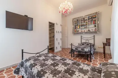 a bedroom with a bed and a flat screen tv at GuestHost - Piramide & Testaccio Design Flat in Rome