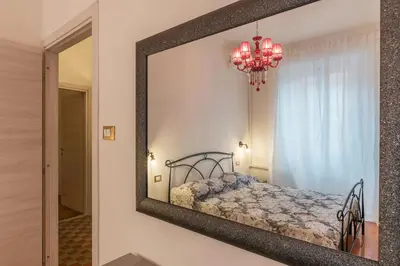 a mirror on a wall with a bed in a room at GuestHost - Piramide & Testaccio Design Flat in Rome