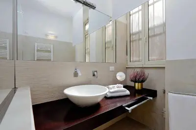 a bathroom with a sink and a large mirror at Restart Accommodations Celimontana in Rome