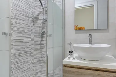 a bathroom with a white sink and a shower at Voyager House Termini - Home and More in Rome