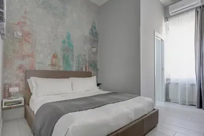 a bedroom with a bed and a wall mural at Voyager House Termini - Home and More in Rome