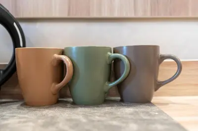 three coffee mugs sitting next to each other on a table at Drago D'Oro GUESTHOUSE - accross from metro Vittorio Emanuele in Rome