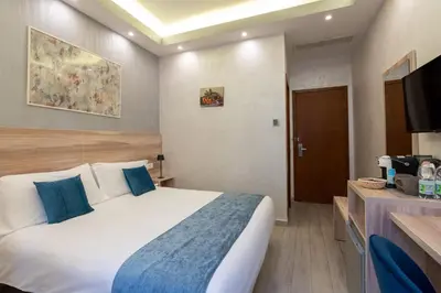 a hotel room with a bed and a television at Drago D'Oro GUESTHOUSE - accross from metro Vittorio Emanuele in Rome