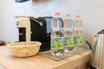 a group of bottles of water sitting on top of a counter at Drago D'Oro GUESTHOUSE - accross from metro Vittorio Emanuele in Rome