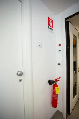a fire extinguisher on the wall of a room at Elements Guest House Roma in Rome