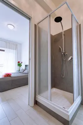 a shower with a glass door in a bathroom at Elements Guest House Roma in Rome