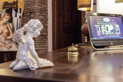 a statue of a girl sitting on a desk with a laptop at Rifugio degli Artisti B&B in Rome