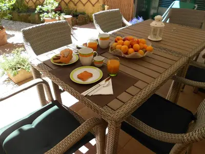 a wooden table with food and oranges on it at B&B Five in Rome