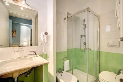 a bathroom with a sink and a glass shower at Residenza Dei Principi in Rome