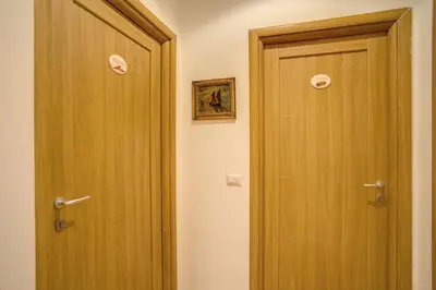 a bathroom with a wooden door next to at Residenza Dei Principi in Rome