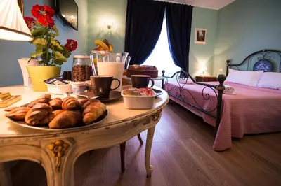 a table with bread and pastries on it in a bedroom at Residenza Dei Principi in Rome