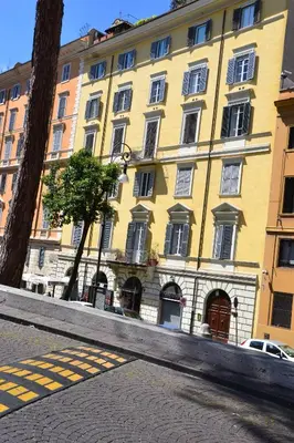 a large yellow building on a city street at Residenza Dei Principi in Rome