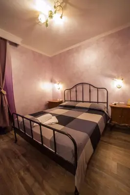 a bedroom with a bed in a room at Iris Guest House in Rome