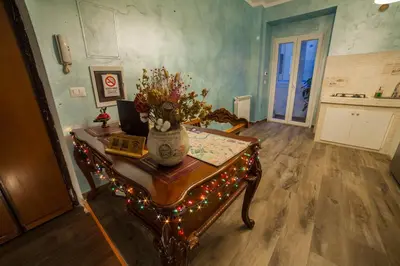 a room with a table with a vase of flowers on it at Iris Guest House in Rome