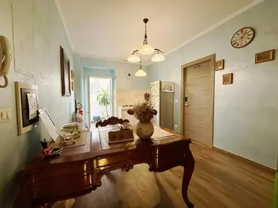 a room with a table with a vase on it at Iris Guest House in Rome