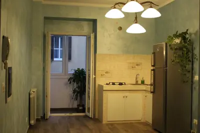 a kitchen with a refrigerator and a sink at Iris Guest House in Rome