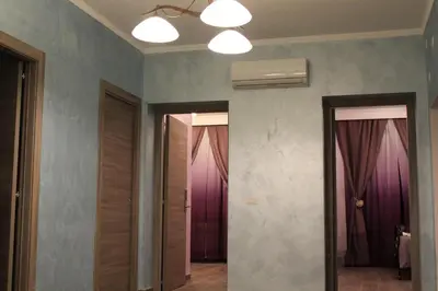 a hallway with two doors and purple curtains at Iris Guest House in Rome