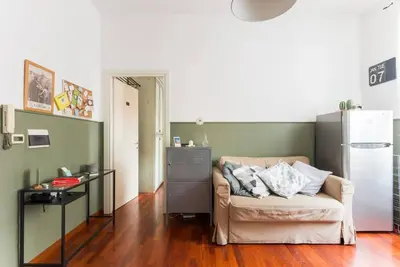 a living room with a couch and a refrigerator at New Suite Amèlie in Rome