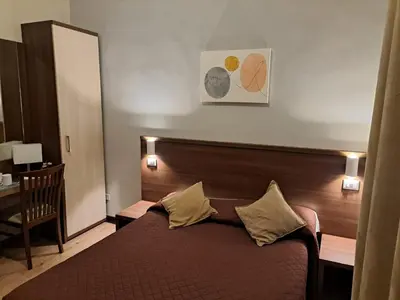 a bedroom with a bed with a wooden head board at Leone in Rome