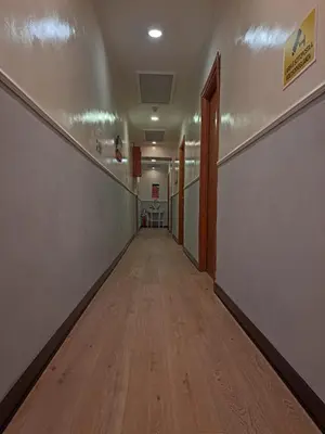 an empty hallway in an office building with a wooden floor at Leone in Rome