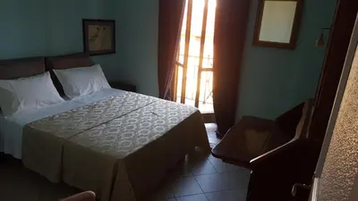 a bedroom with a bed in a room with a window at Casa di Walter al Pigneto in Rome
