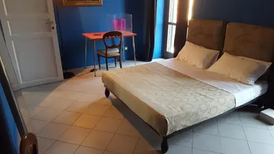 a bedroom with a bed and a table and a chair at Casa di Walter al Pigneto in Rome