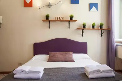 a bedroom with a bed with two towels on it at Monti house in Rome