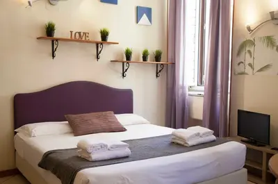 a bedroom with a bed with towels on it at Monti house in Rome