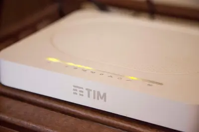 a white router sitting on a wooden table at Monti house in Rome
