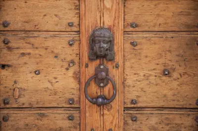 a wooden door with a face on it at Monti house in Rome