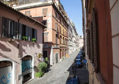 an alley with buildings and cars parked on a street at Monti house in Rome