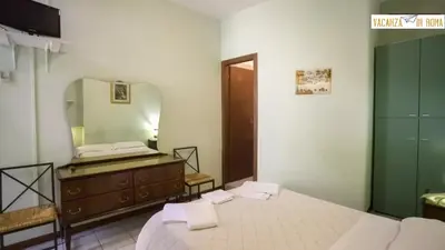 a bedroom with a bed and a dresser and a mirror at Al Pantheon Con Thomas Mann in Rome