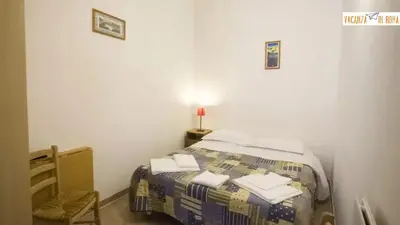 a bedroom with a bed and a chair in a room at Al Pantheon Con Thomas Mann in Rome