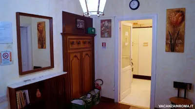 a hallway with a clock on the wall and a mirror at Al Pantheon Con Thomas Mann in Rome