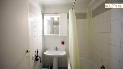 a white bathroom with a sink and a bath tub at Al Pantheon Con Thomas Mann in Rome