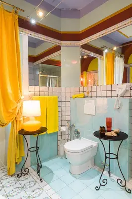 a bathroom with a toilet and a yellow towel at Appartamenti MarcoAurelio49 in Rome